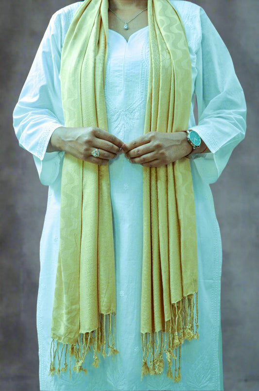 Elegant beige jacquard stole draped stylishly over a white kurta with delicate fringe details
