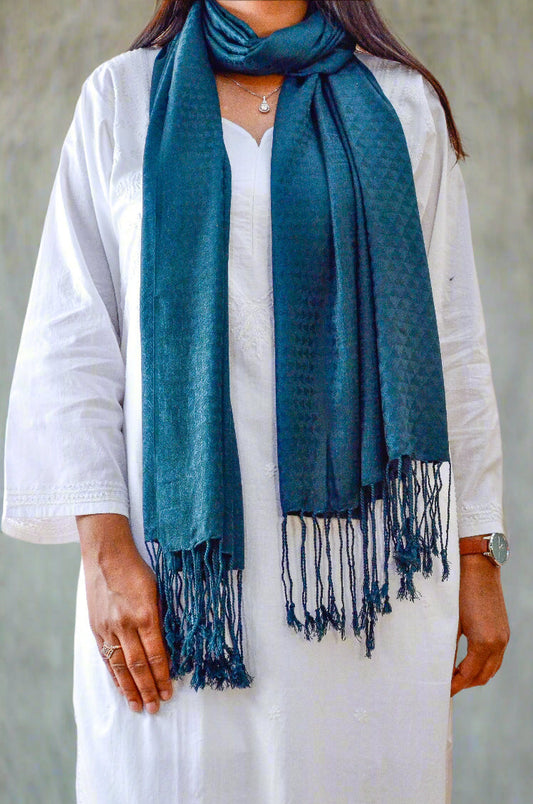 Stylish black green jacquard stole draped elegantly over a white outfit with fringed edges