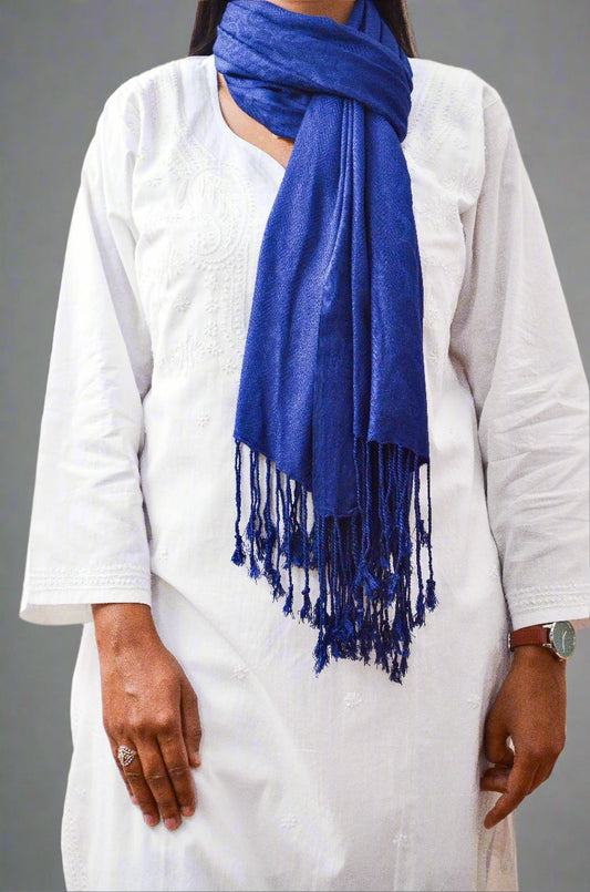 Elegant blue jacquard stole draped stylishly, ideal for adding warmth and flair to any outfit