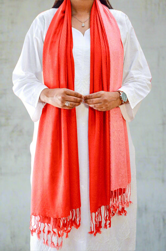 Elegant crimson jacquard stole worn elegantly over a white kurta, featuring fringed edges