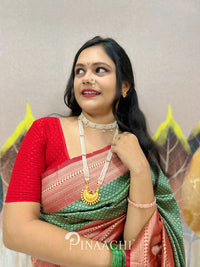 Model wearing a green lichi silk saree paired with traditional jewelry for an elegant look