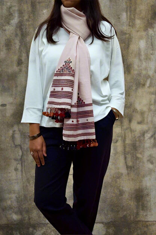 Elegant hand woven merino wool stole in soft pink with decorative fringes and intricate patterns
