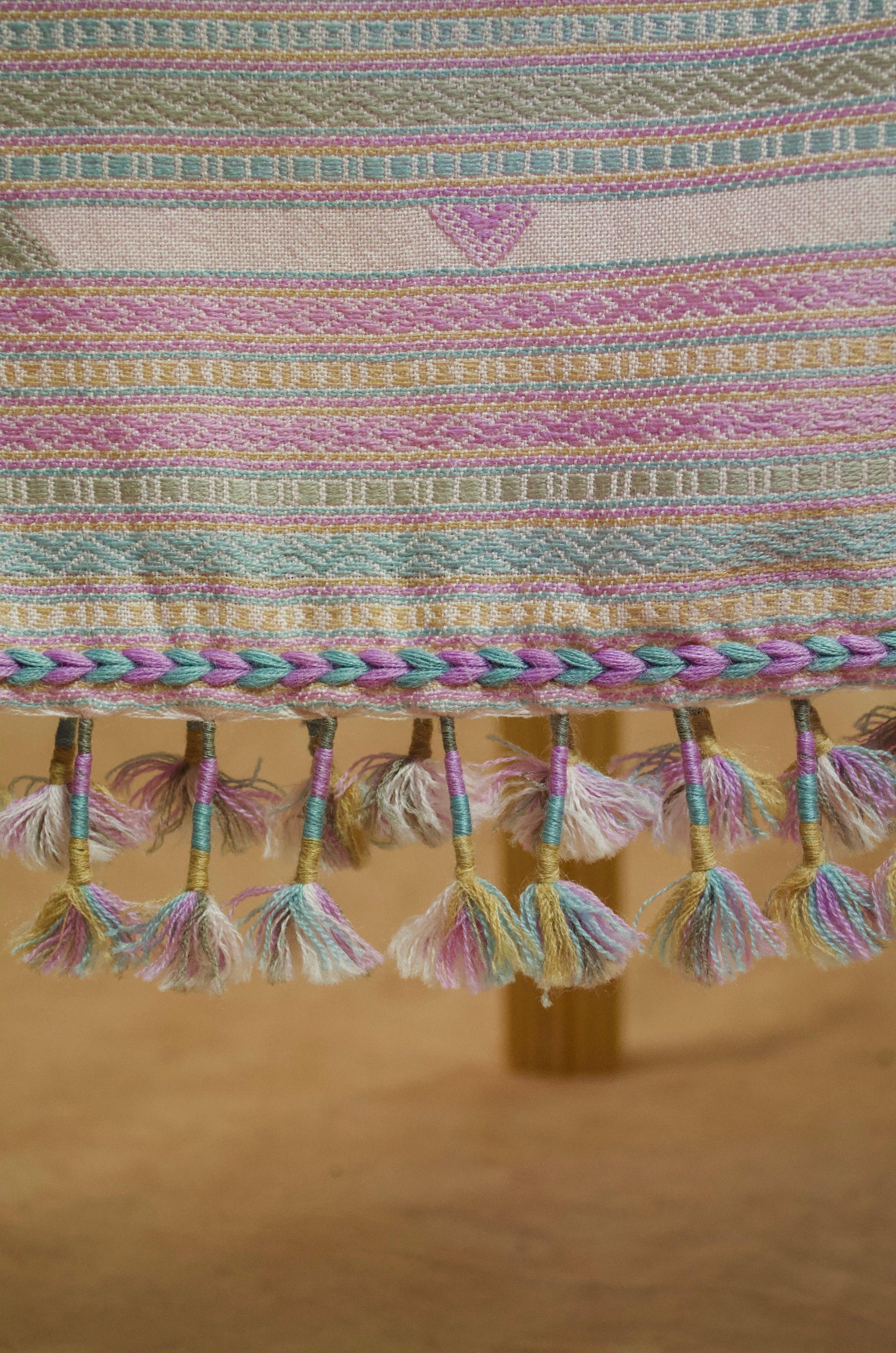 Handwoven merino wool silk shawl featuring colorful tassels and intricate patterns