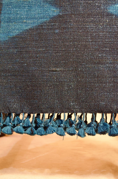Handwoven merino wool stole with intricate patterns and decorative tassels for stylish warmth