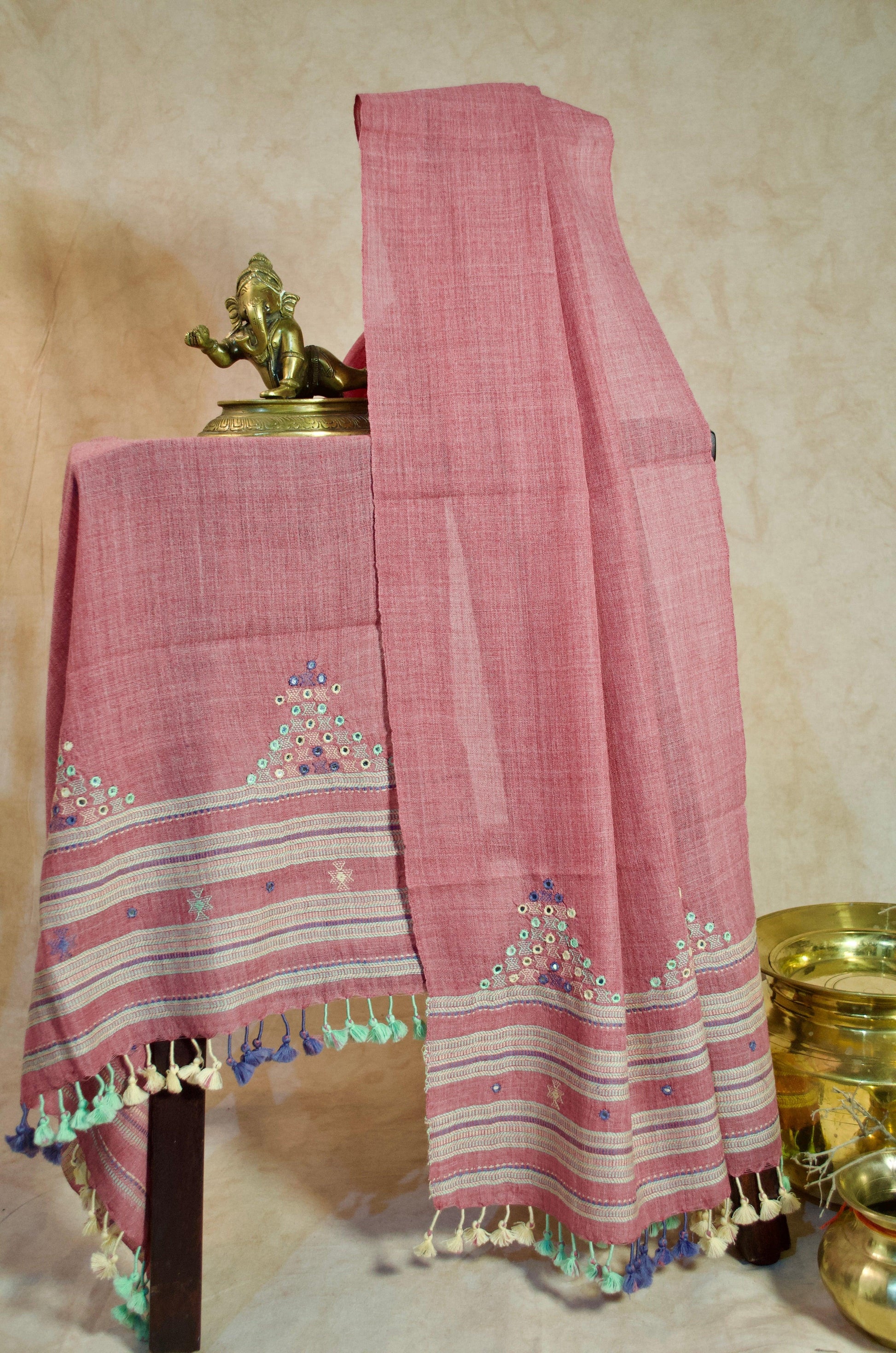 Handwoven merino wool stole with intricate embroidery and colorful tassels for elegant styling