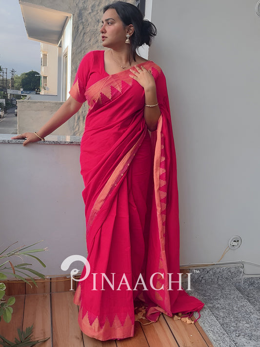 Woman in a pink saree standing on a balcony with 'Pinaachi' branding.