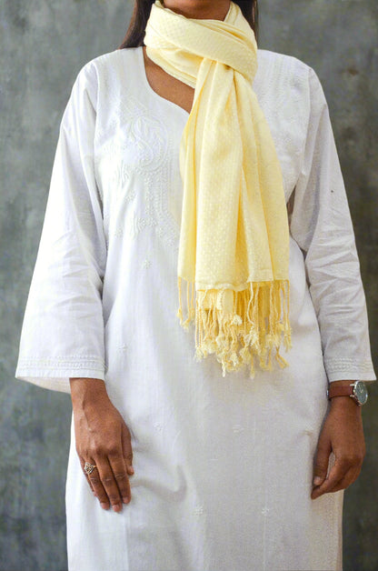 Pinaachi ivory jacquard stole draped elegantly over a white kurta with tassel detailing