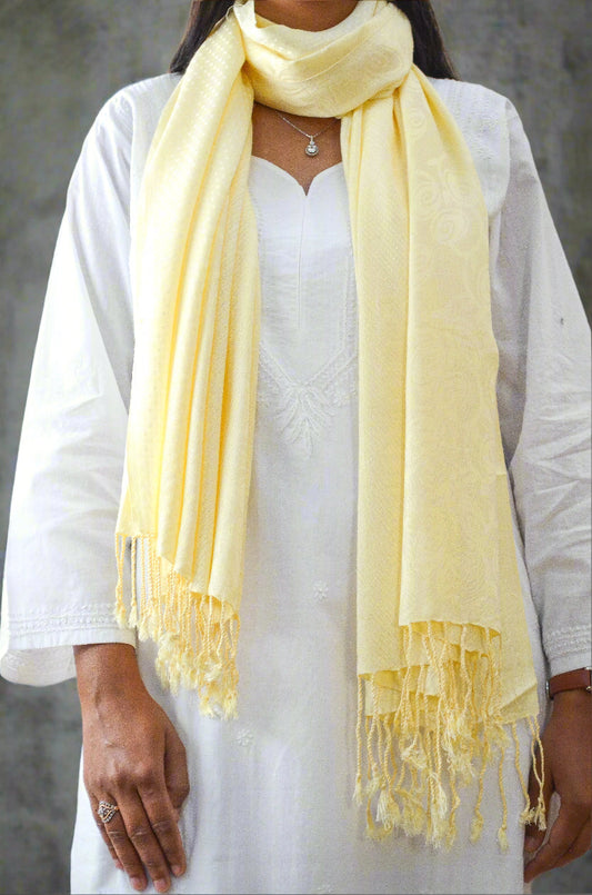 Elegant ivory jacquard stole with soft texture draped over a model for stylish layering