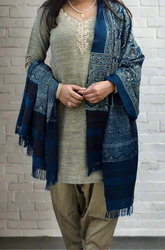 Elegant Merino wool Ajrakh shawl draped over a traditional outfit with intricate patterns