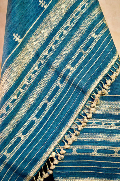 Elegant merino wool indigo shawl with intricate patterns and tassels, perfect for stylish warmth.
