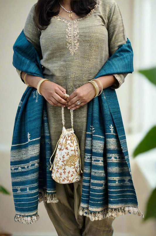 Elegant woman wearing a merino wool indigo shawl over a traditional outfit for a stylish look