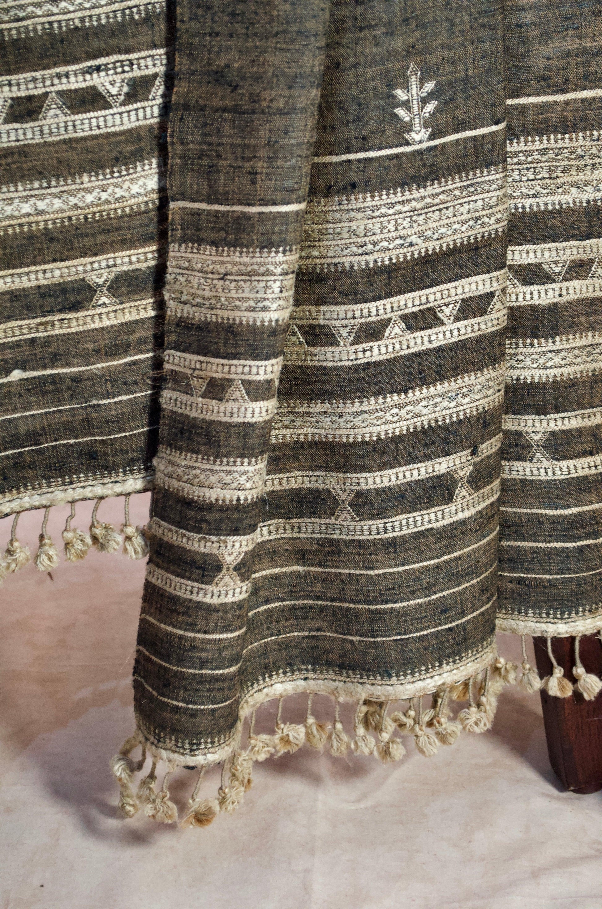 Elegant merino wool tasar silk stole with intricate patterns and tassels, perfect for stylish layering.