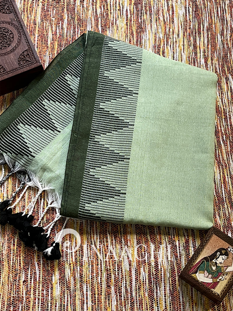 Sage green cotton saree by Pinaachi with traditional patterns and tassels for elegant styling