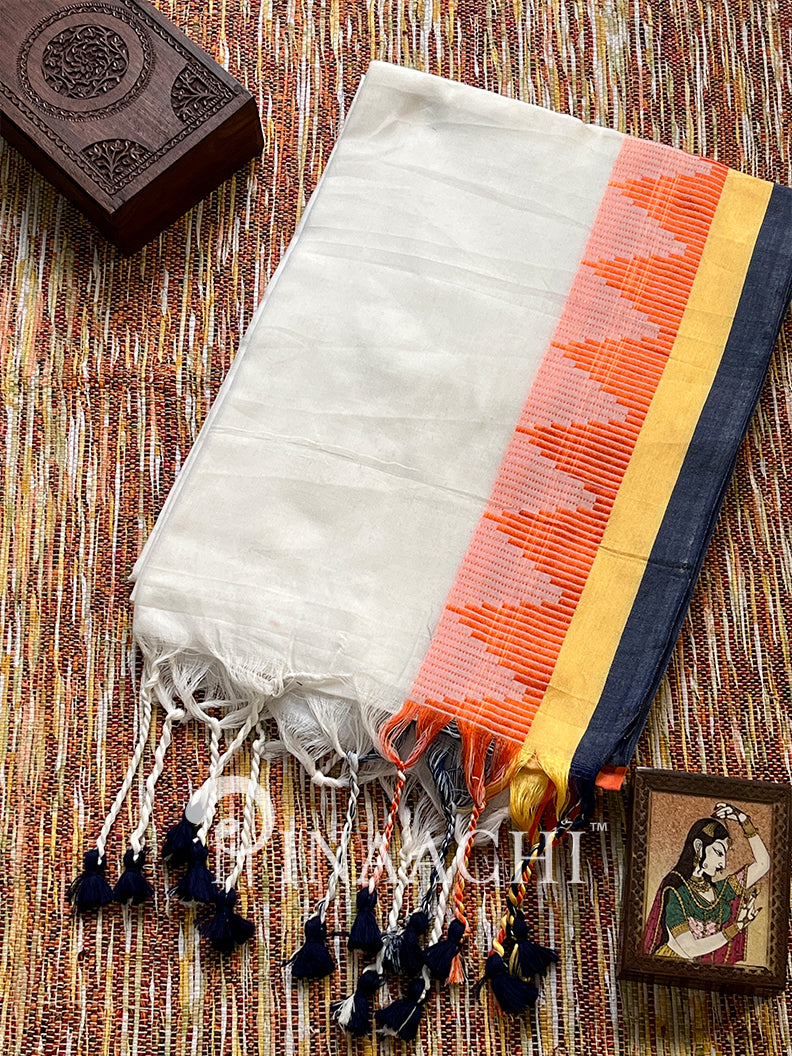 Handspun white cotton saree with colorful borders and tassels, perfect for elegant occasions.