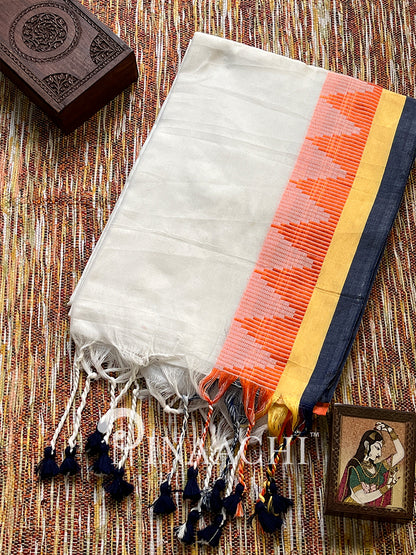 Handspun white cotton saree with colorful borders and tassels, perfect for elegant occasions.