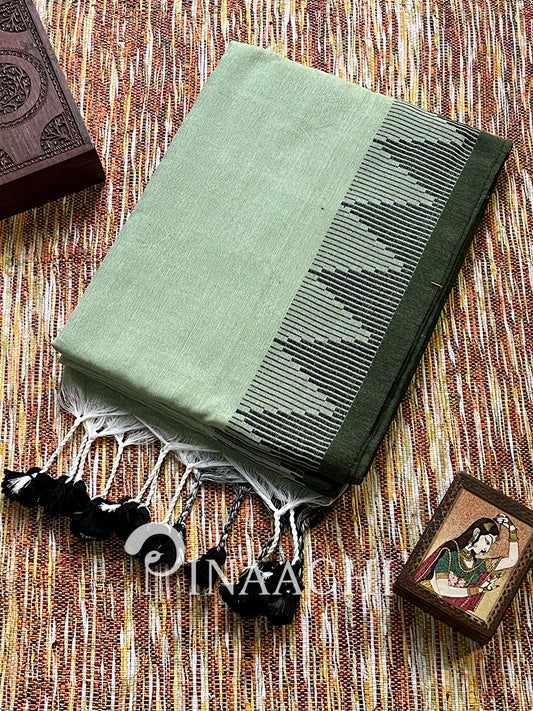 Elegant sage green cotton saree featuring intricate black border and tassels for traditional wear