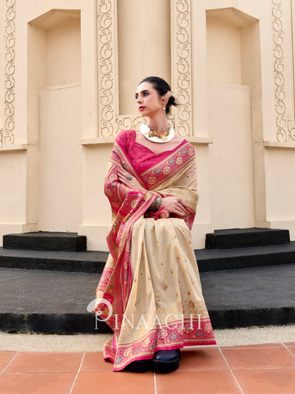 Elegant Banarasi silk saree for wedding in cream and pink with intricate golden embroidery