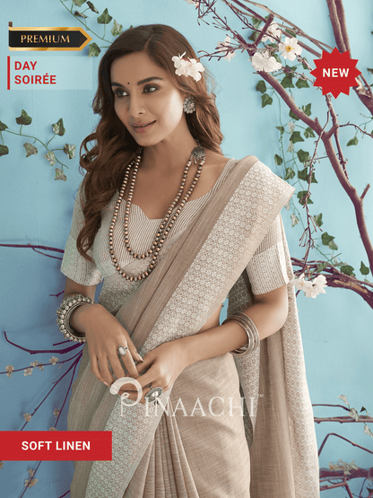 Elegant model in a beige soft linen saree showcasing intricate patterns and delicate styling accessories