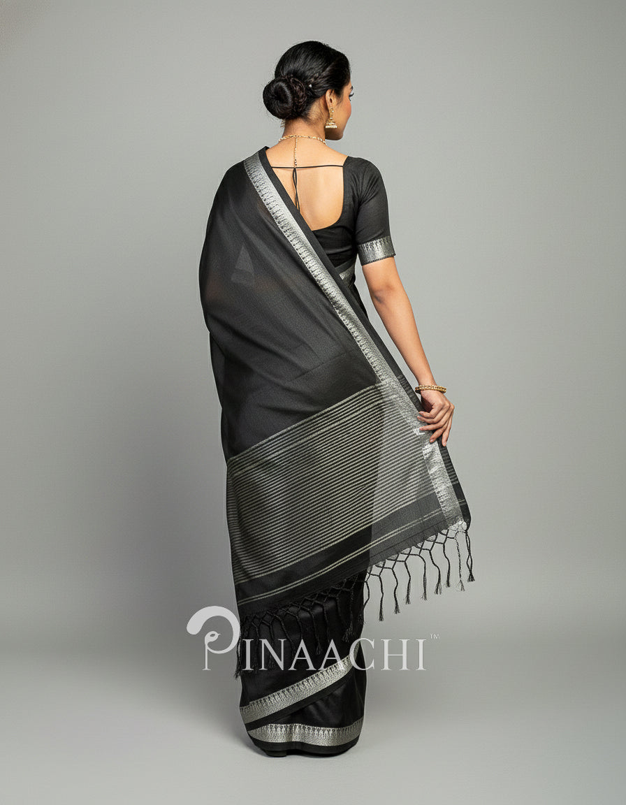 Elegant black mul tissue handloom saree with intricate silver detailing and tassel border