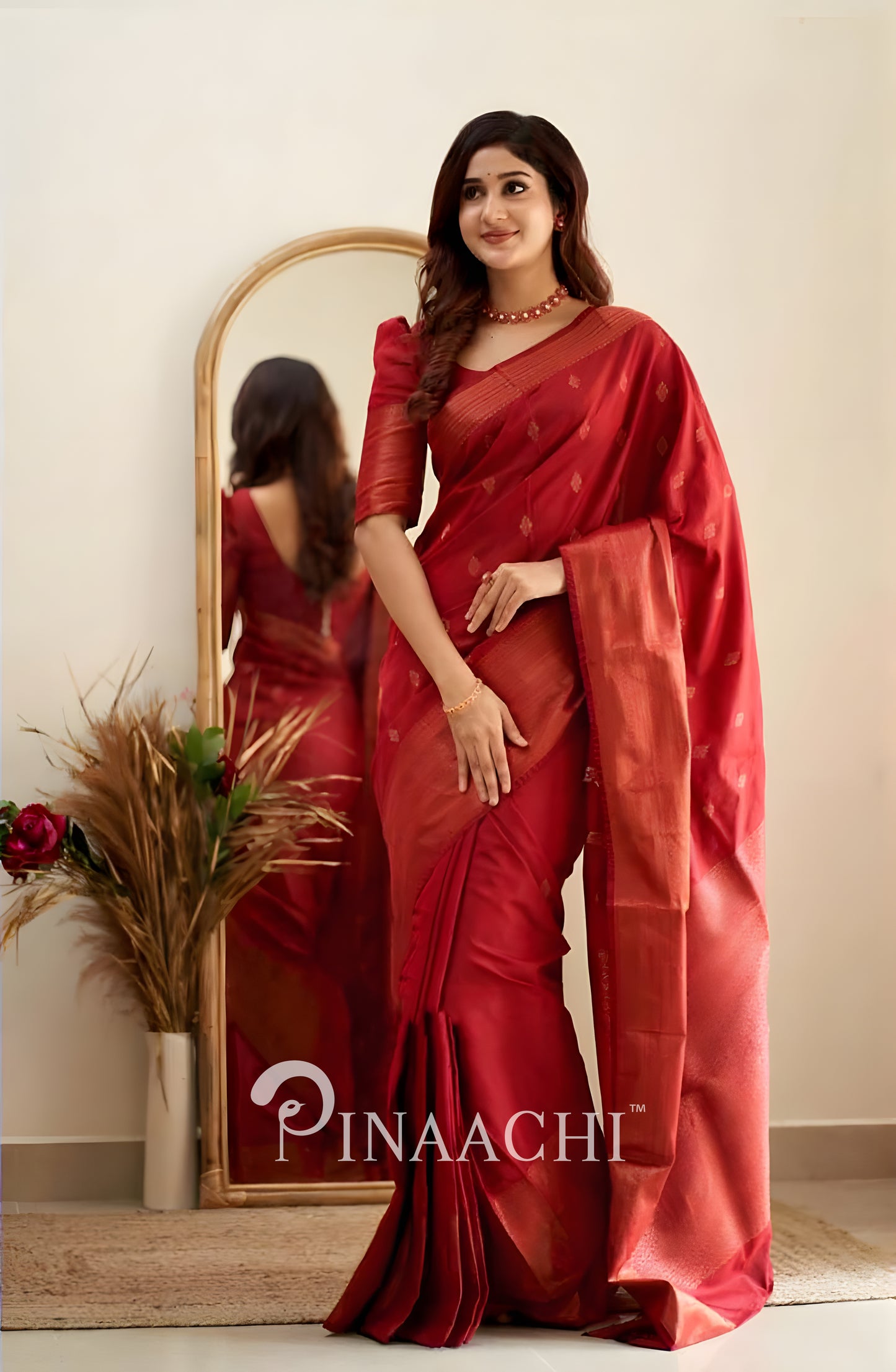 Pinaachi Cherry Red Litchi Silk Saree draped elegantly, showcasing its luxurious texture and design