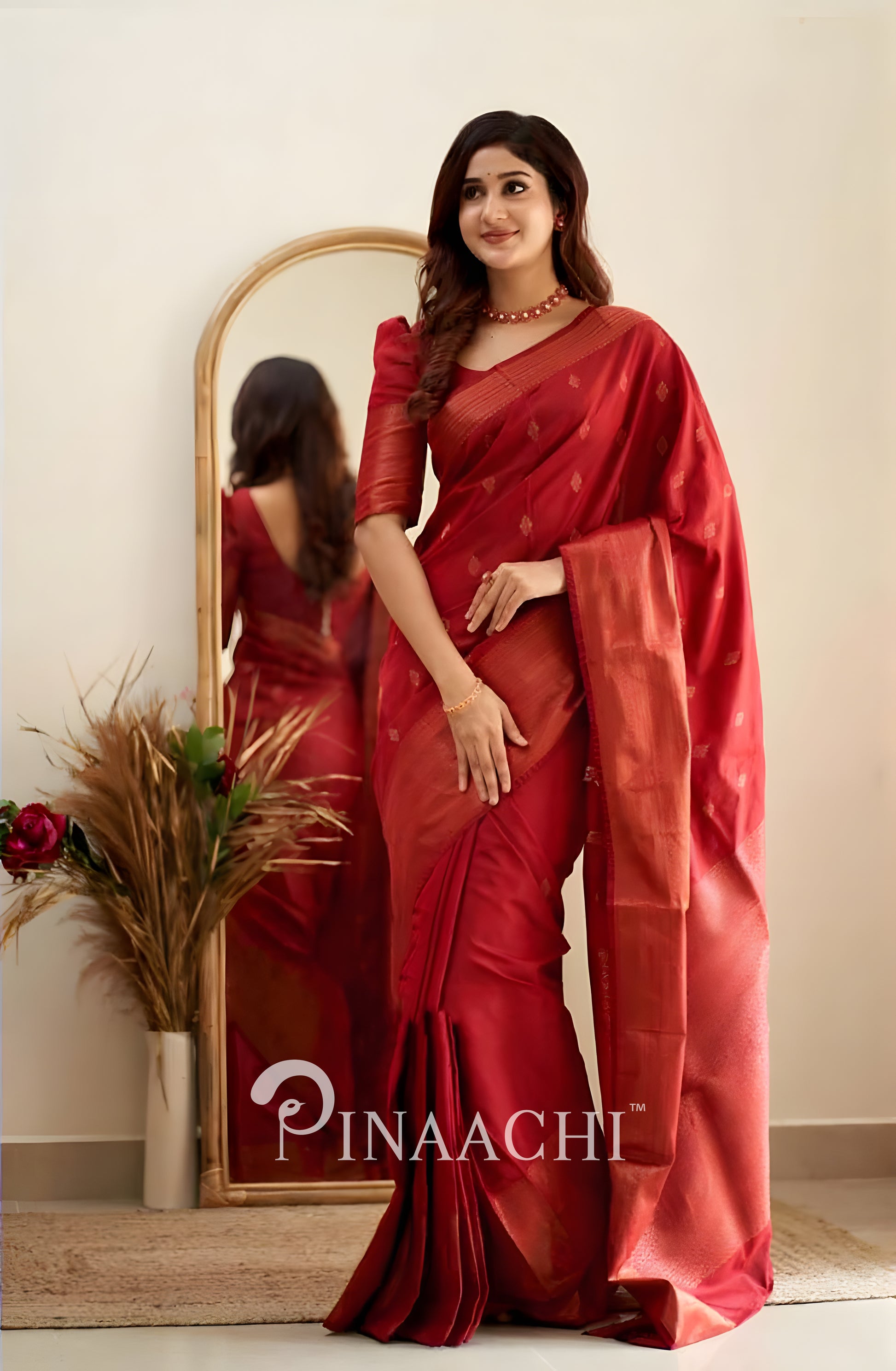 Pinaachi Cherry Red Litchi Silk Saree draped elegantly, showcasing its luxurious texture and design