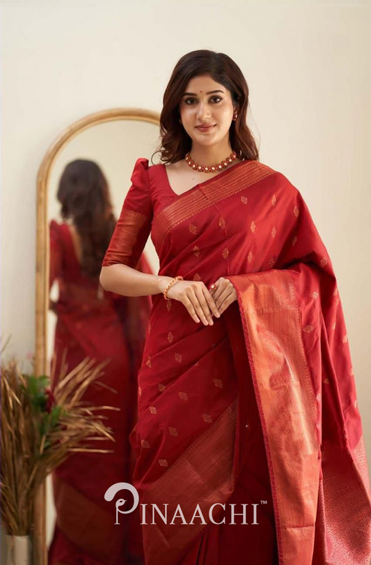 Woman wearing Pinaachi Cherry Red Litchi Silk Saree with traditional gold motifs and matching blouse