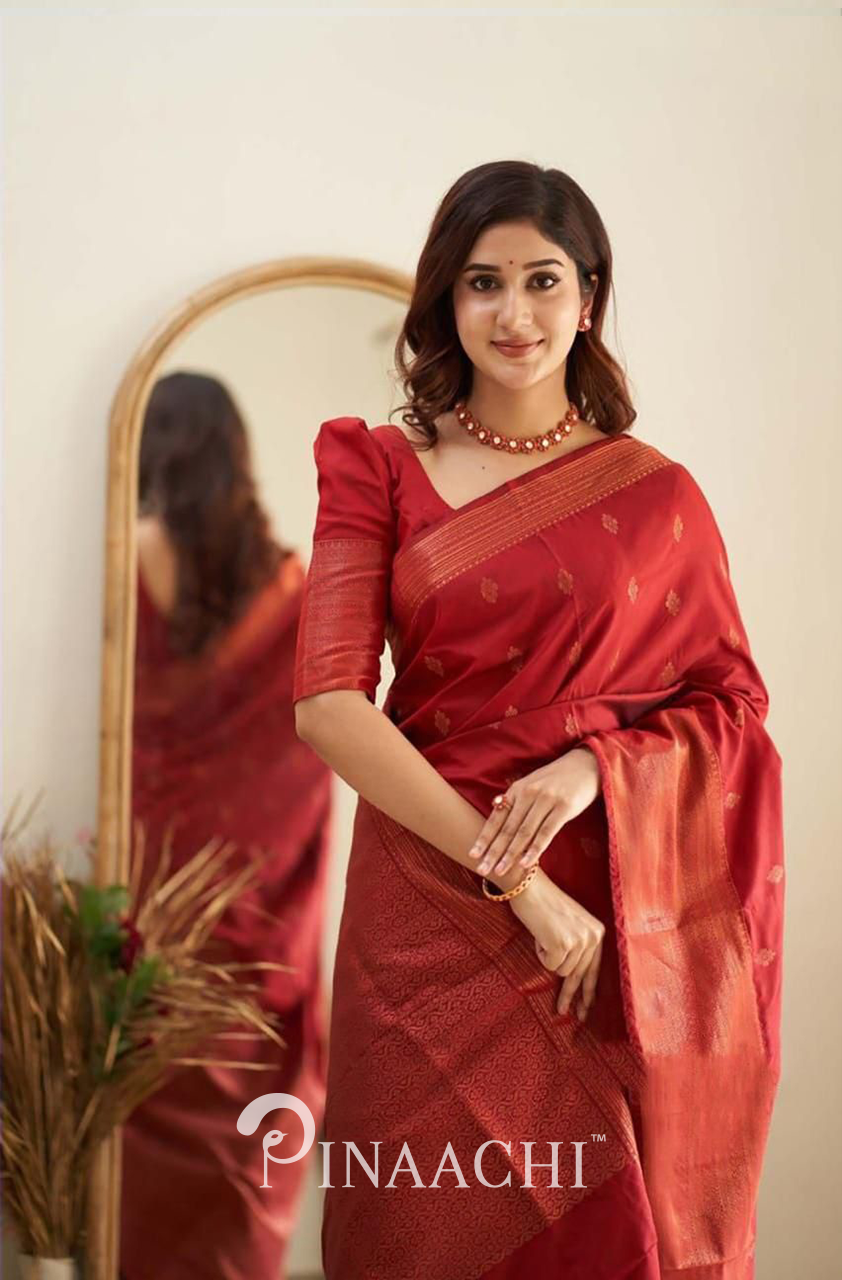 Woman wearing Pinaachi Cherry Red Litchi Silk Saree with gold motifs and matching blouse