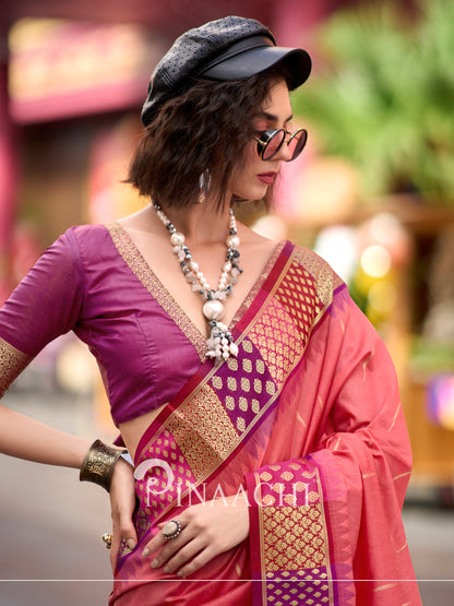 Model wearing a coral Banarasi silk saree paired with a stylish blouse and accessories