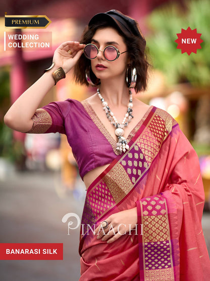 Stylish model wearing a coral Banarasi silk saree with elegant blouse and traditional jewelry
