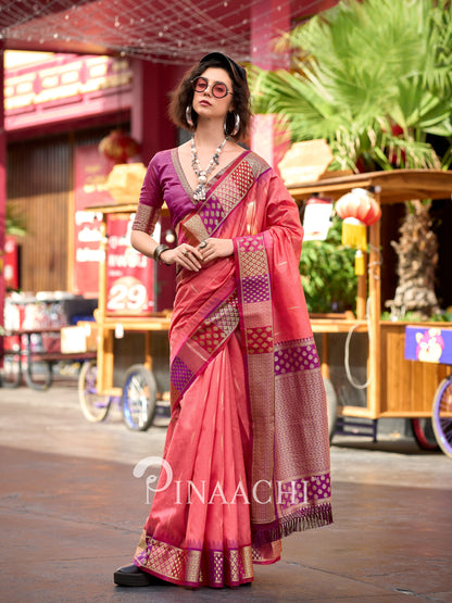 Elegant coral Banarasi silk saree by Pinaachi with intricate borders and vibrant colors