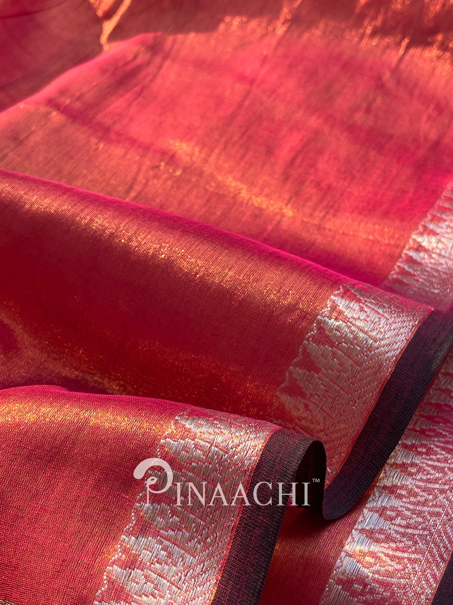 Elegant coral blush mul tissue saree by Pinaachi with shimmering texture and contrasting borders