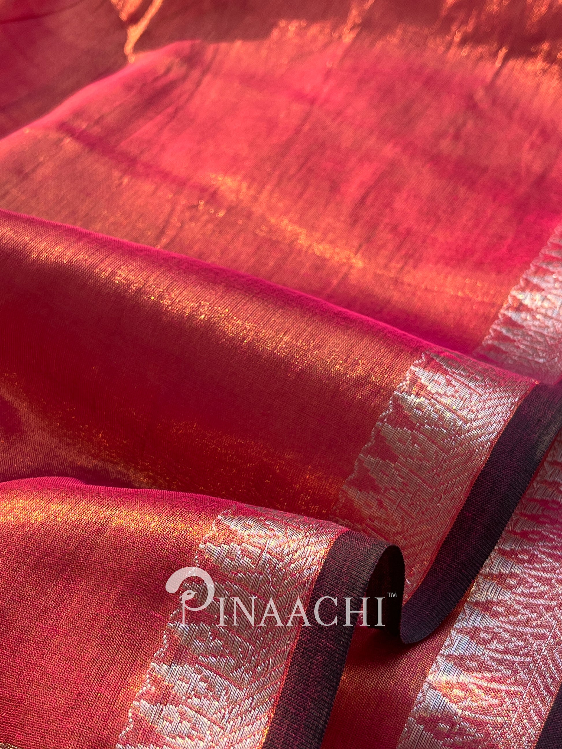 Elegant coral blush mul tissue saree by Pinaachi with shimmering texture and contrasting borders