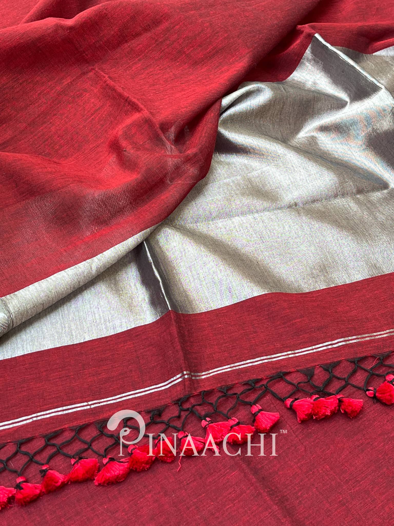 Pinaachi deep red handloom mulmul saree with silver borders and elegant tassel detailing