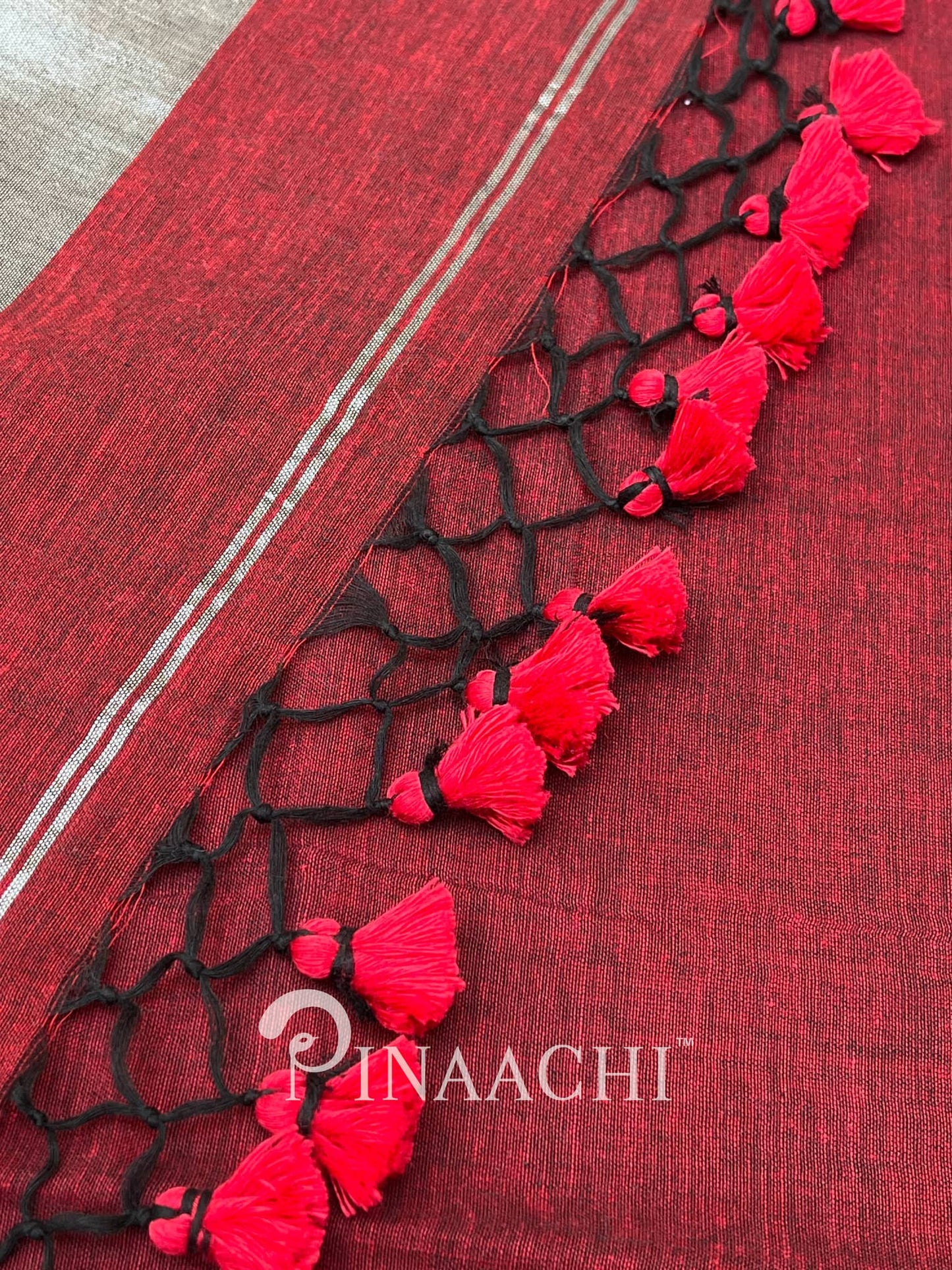 Pinaachi deep red handloom mulmul saree with black tassel detailing and elegant border