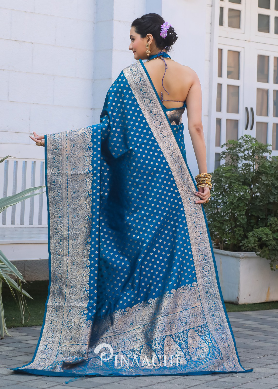 Woman wearing Pinaachi Firozi Banarasi silk saree with intricate silver zari border and polka dot design