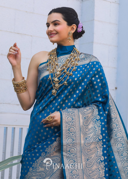Pinaachi Firozi Banarasi silk saree with intricate gold designs worn by a smiling woman with traditional jewelry
