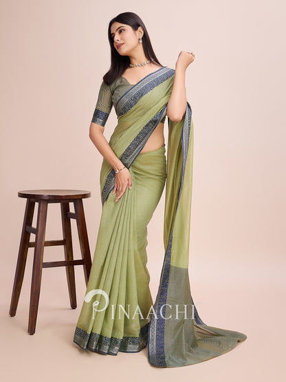 Pinaachi green cotton saree with woven border, elegantly draped with a traditional look
