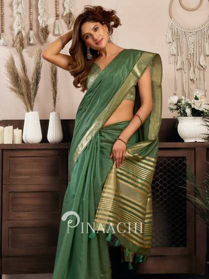 Stylish woman wearing a green cotton silk saree with traditional design, perfect for festive occasions