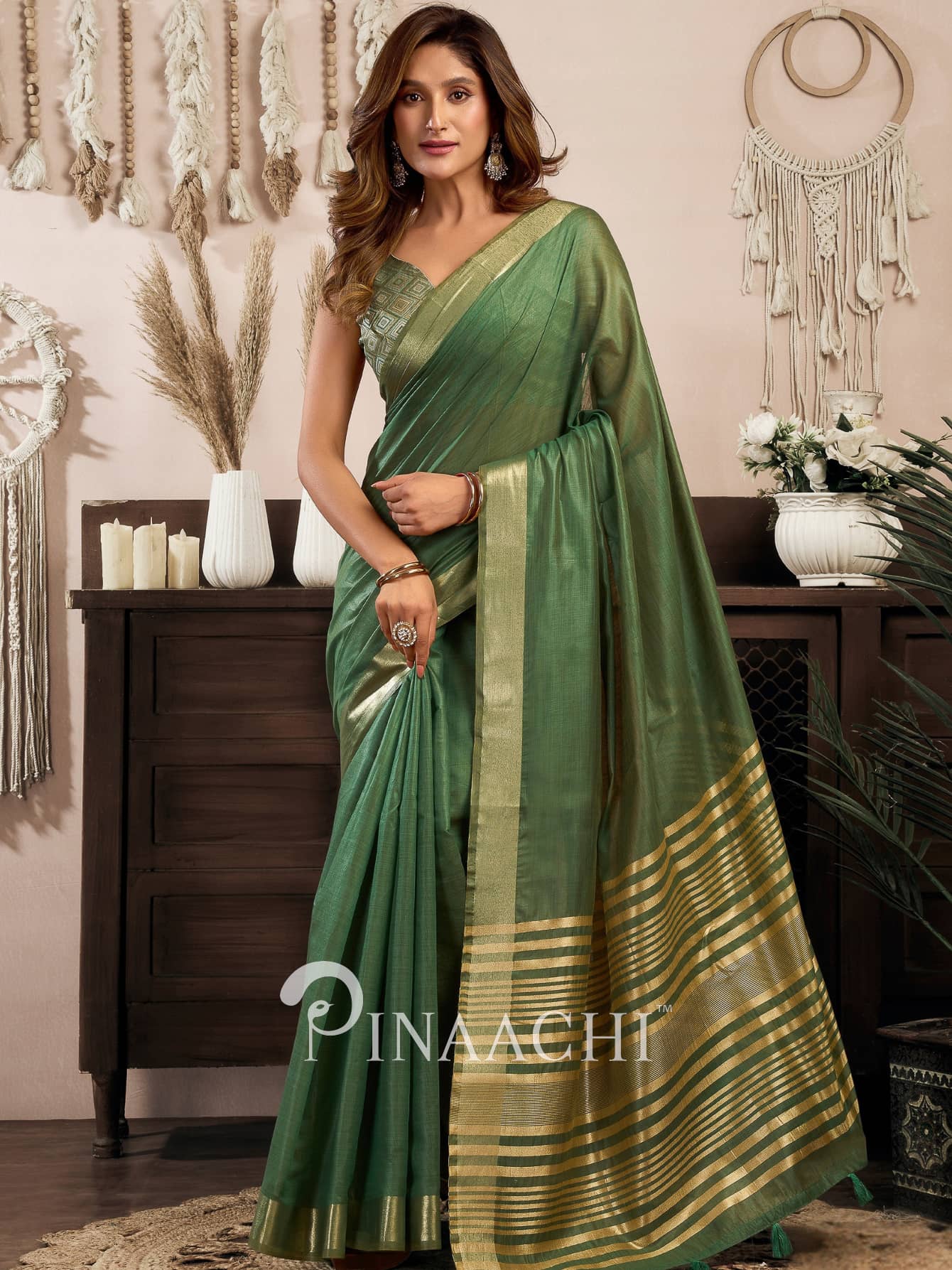 Elegant green cotton silk saree by Pinaachi featuring golden border and stylish drape