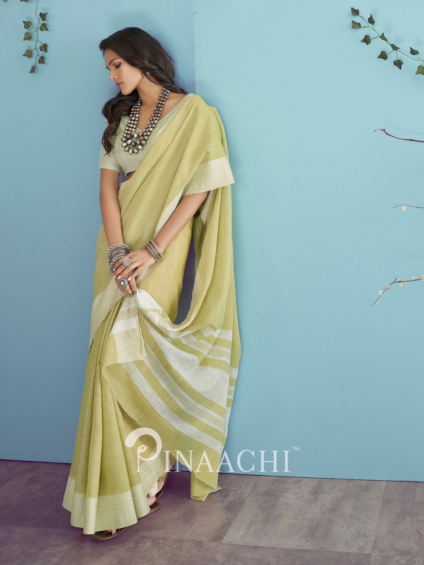 Elegant green linen saree by Pinaachi with a stylish drape and subtle design details