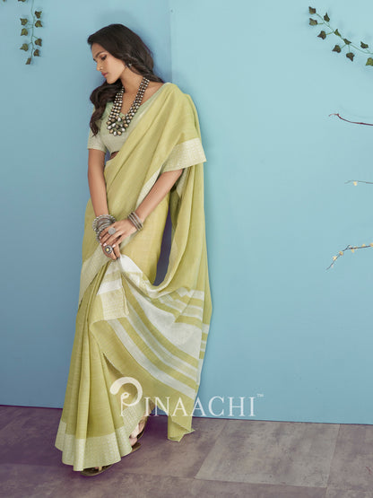 Elegant green linen saree by Pinaachi with a stylish drape and subtle design details