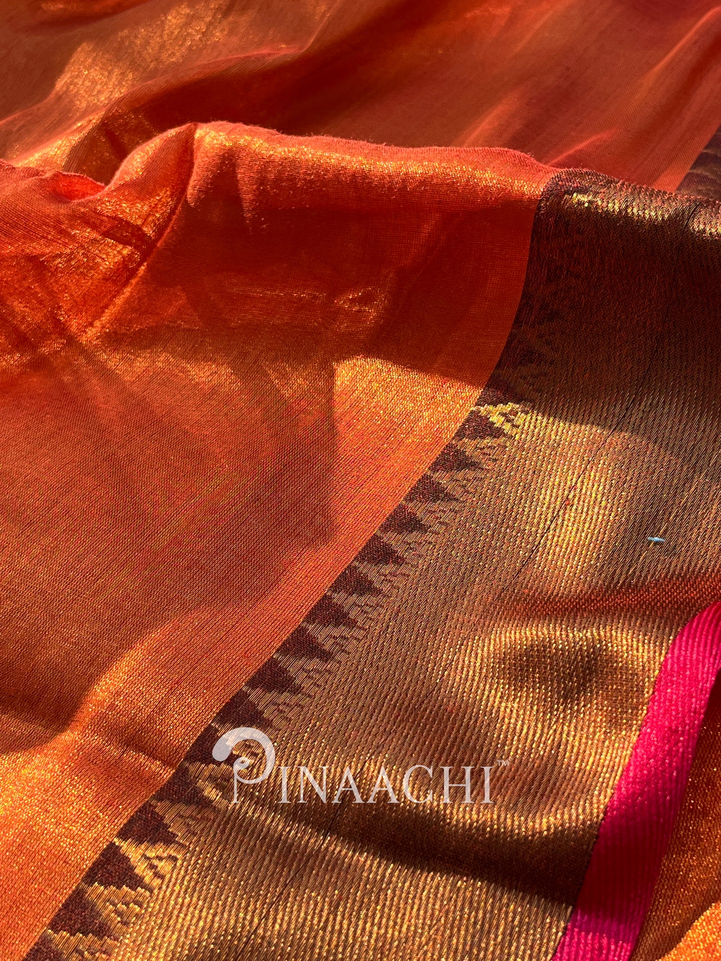 Handloom copper tissue silk saree in vibrant orange with intricate border detailing