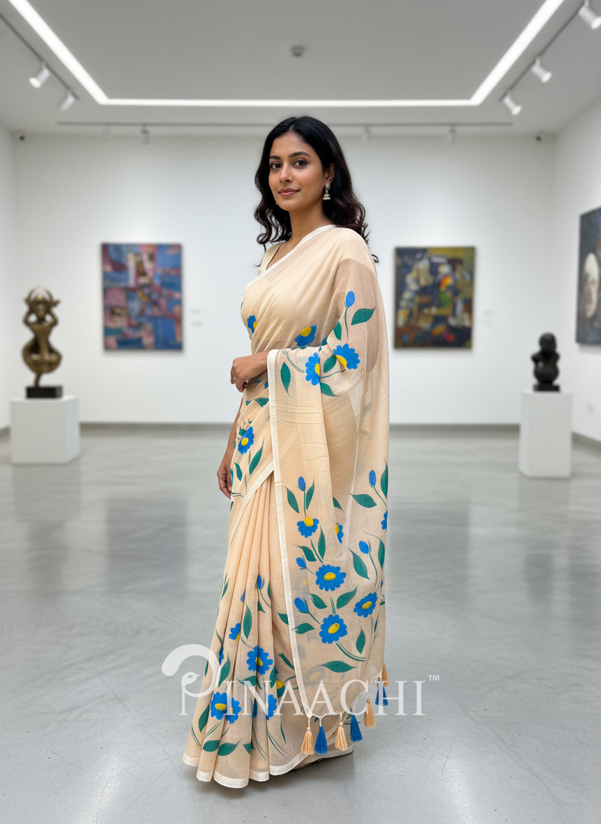 Pinaachi beige handloom handpainted mulmul saree with vibrant blue floral patterns
