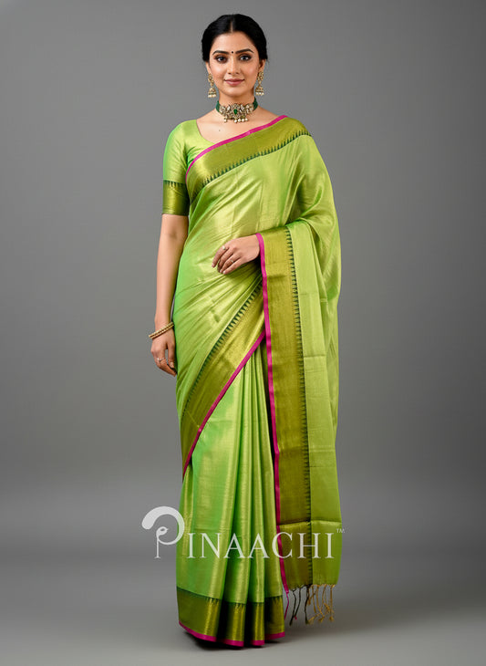 Elegant handloom tissue silk saree in green with pink borders, perfect for festive occasions