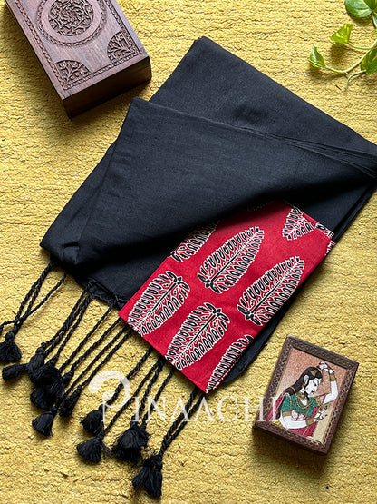 Handspun black cotton saree with red border and decorative tassels for elegant styling