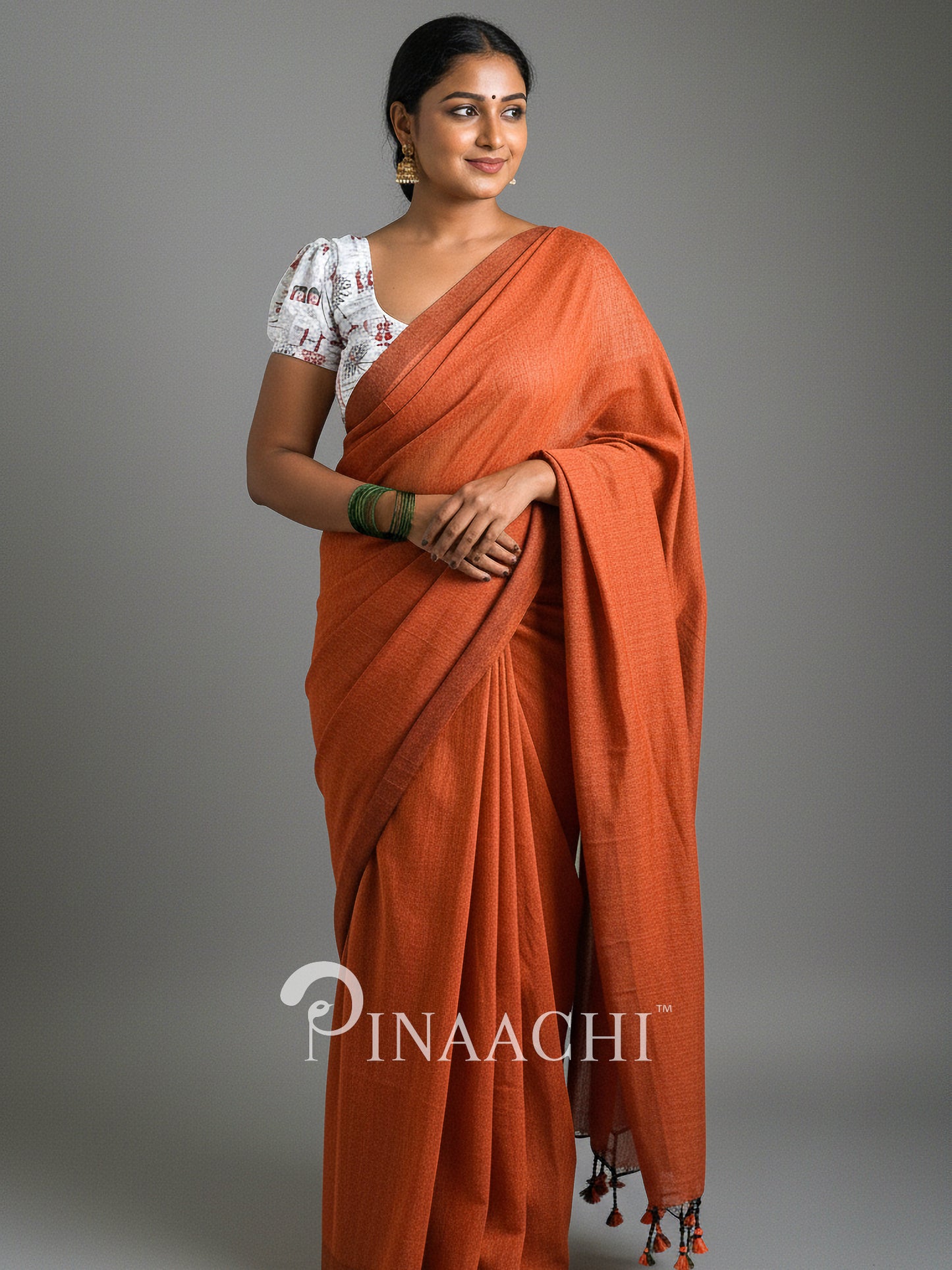 Elegant handspun rust orange cotton saree by Pinaachi, styled with a traditional blouse