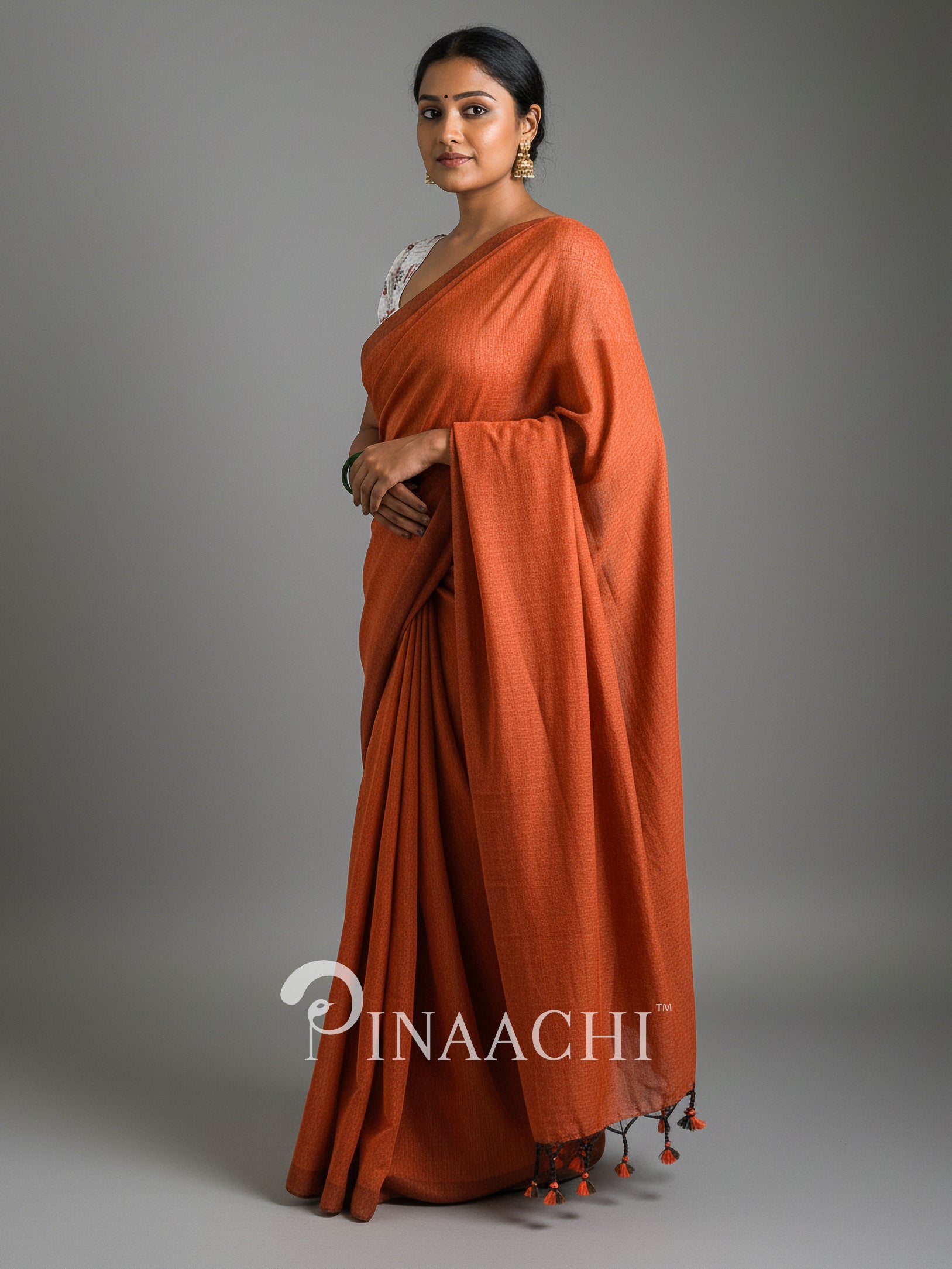 Elegant handspun rust orange cotton saree from Pinaachi with delicate tassels and classic drape