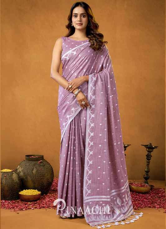 Elegant woman wearing a light purple pinaachi jamdani saree with white geometric patterns and tassels