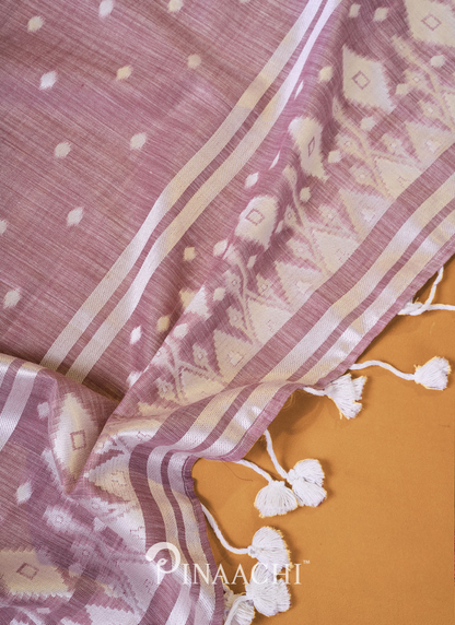 Light purple pinaachi jamdani saree with white geometric patterns and tassels on beige background