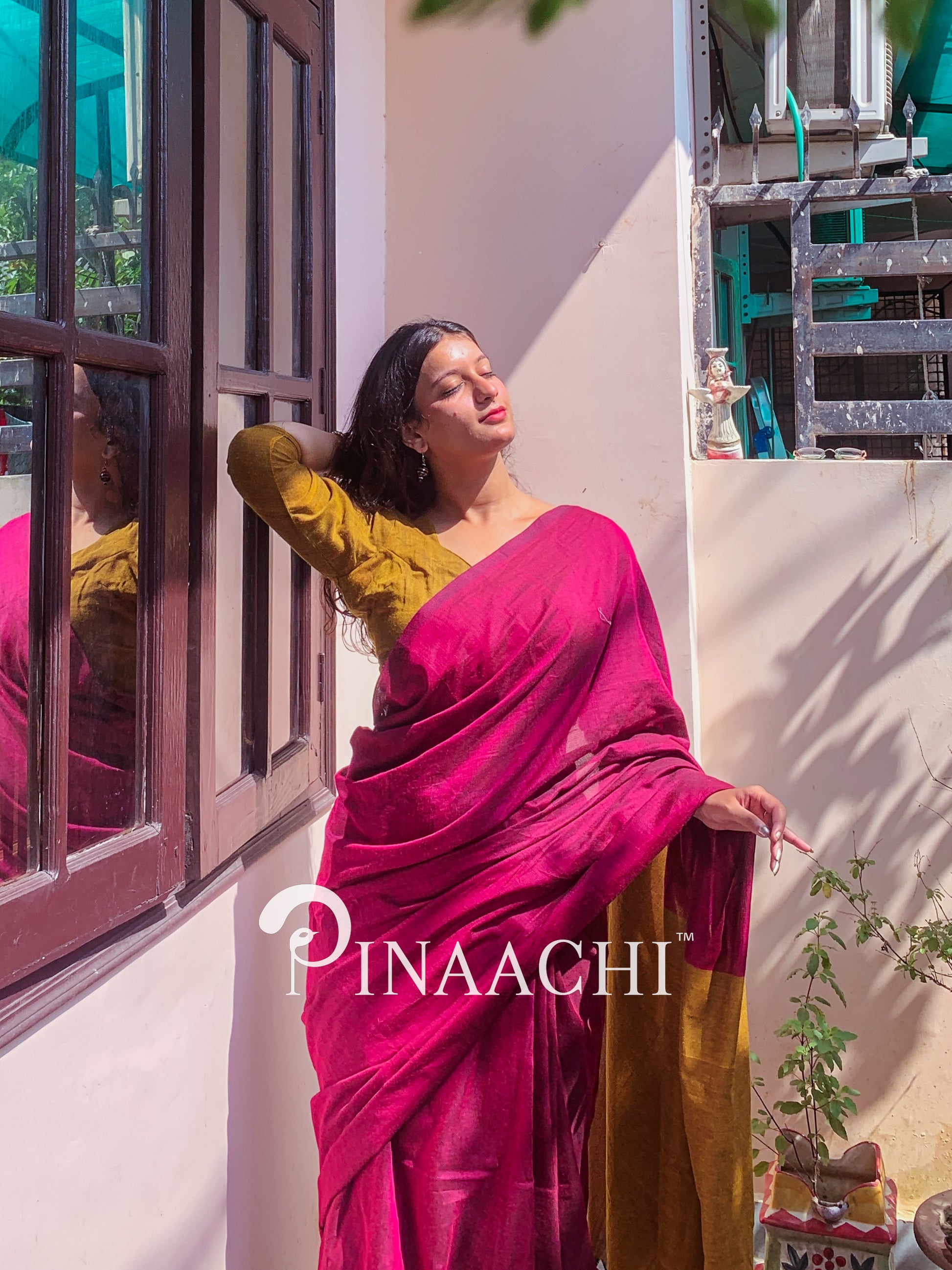 Model showcasing a magenta pink cotton handloom saree with a contrasting blouse by Pinaachi